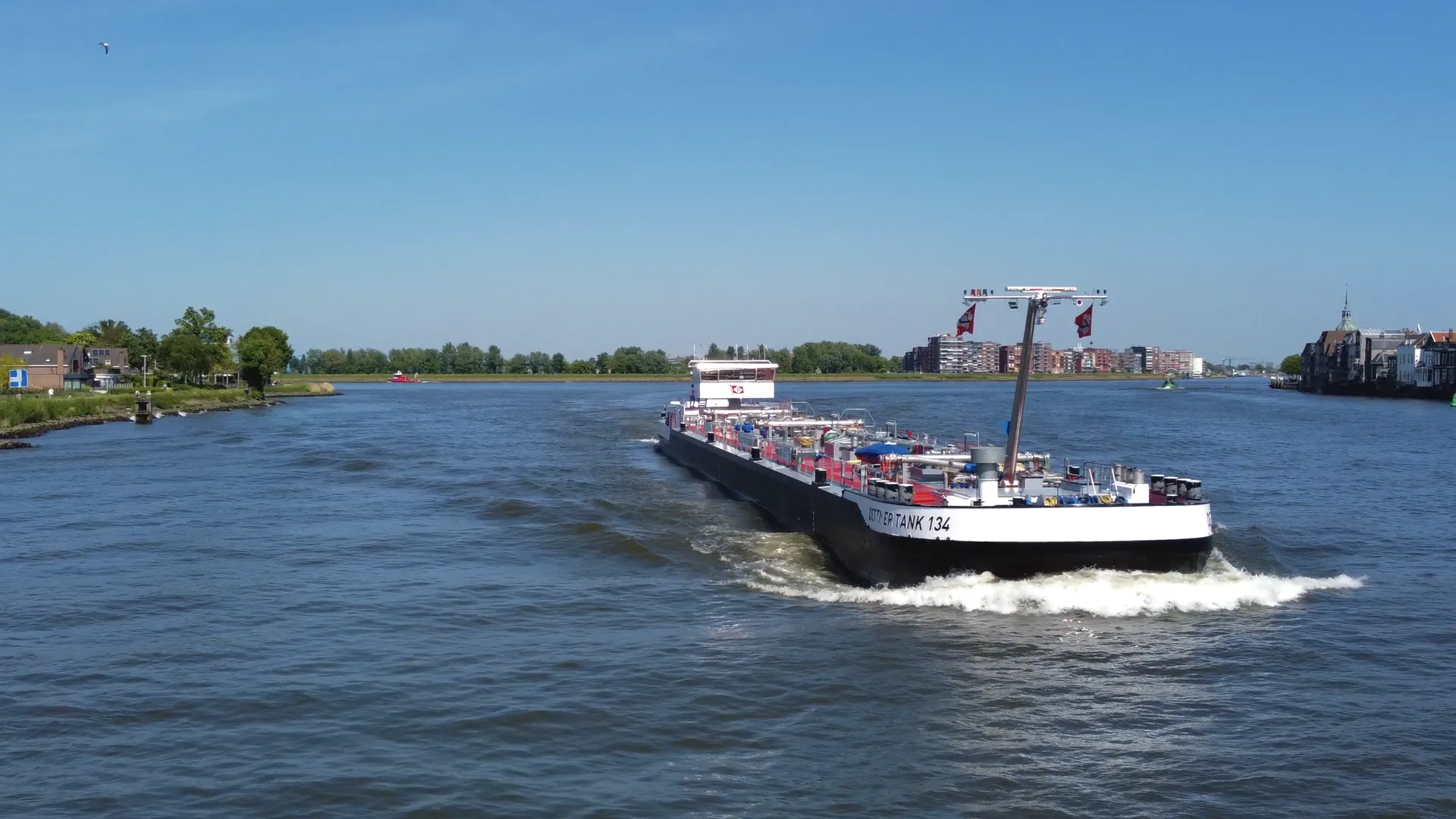 Inland tanker Dettmer Tank 134 on the river with CFD-optimized ship propellers for efficient propulsion.