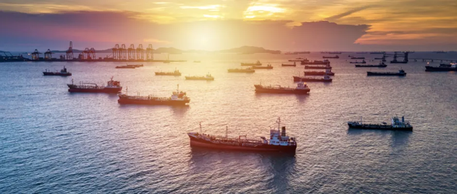 LNG-fuelled sea-going vessels at anchor near terminal during dusk