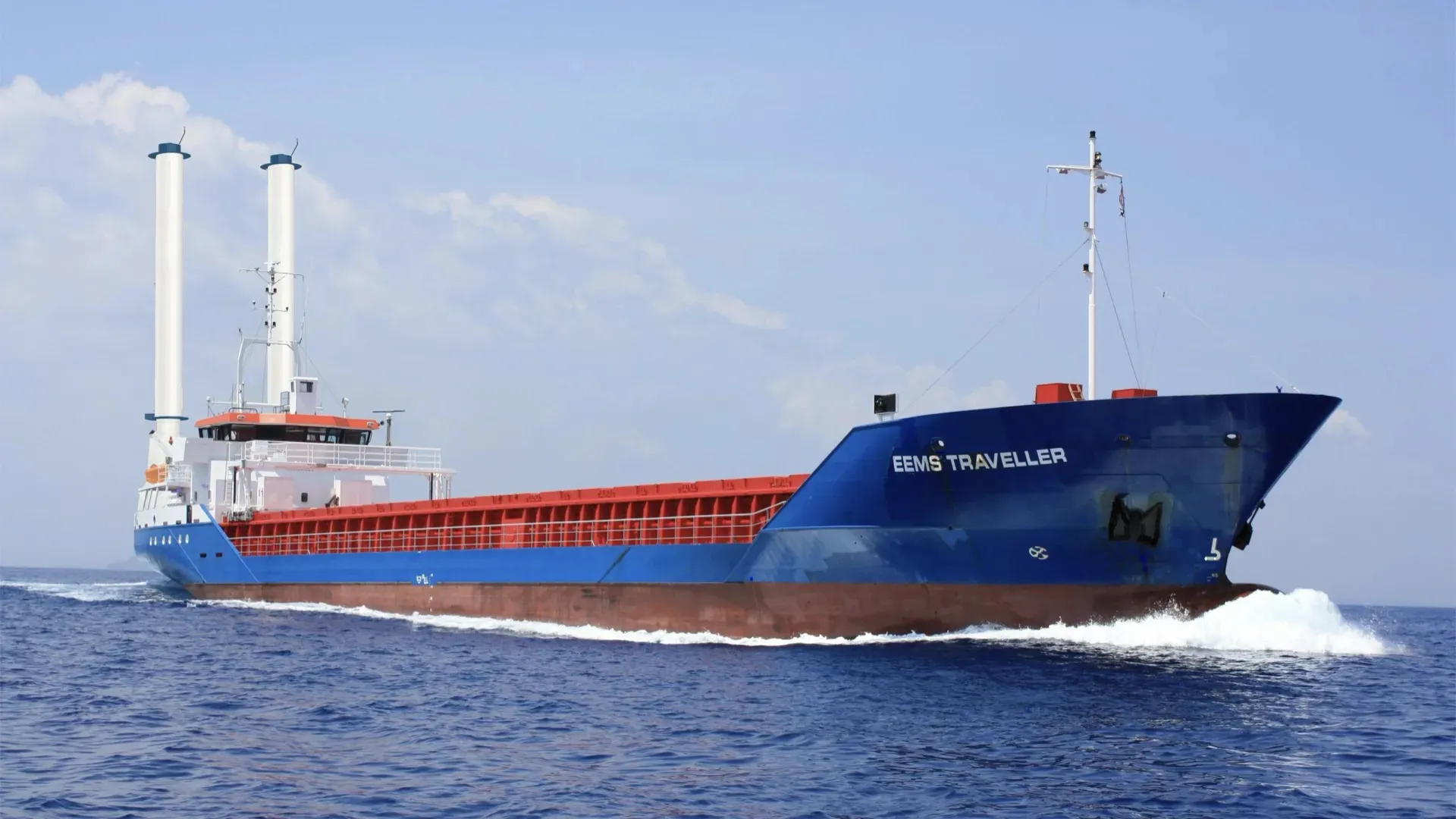 Short-sea cargo vessel sailing open sea with two 17-meter suction sails as wind-assisted propulsion